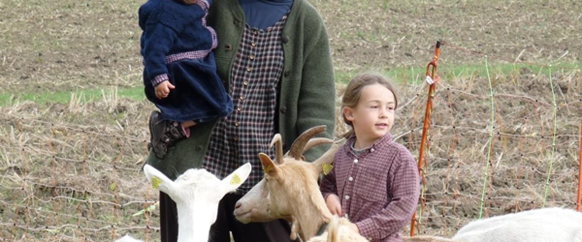 Mother with children and goats