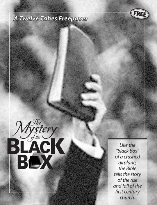 Man's hand holding up a large black bible